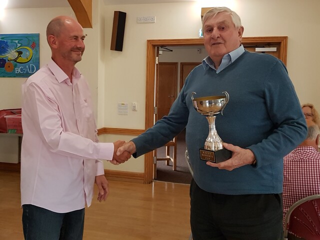 Michael Branfoot being presented with the Christine Jones Trophy for 2024 by Steve Williams (the 2023 winner)